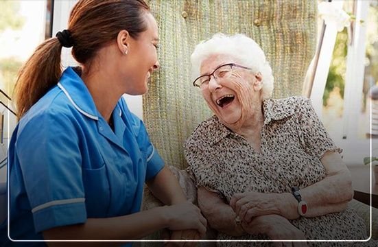 Home Health Care Skilled Nurse with Senior Laughing